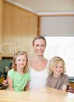 Mother with daughter and son in the kitchen together