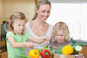 Mother with daughter and son preparing salad