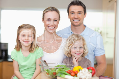 Family standing in kitchen