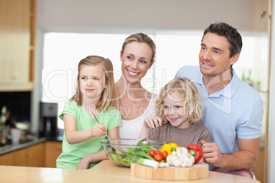 Family standing next to salad