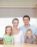 Cheerful family standing in the kitchen together