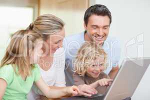 Family using notebook in the kitchen