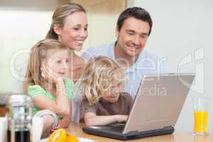 Family using the internet in the kitchen