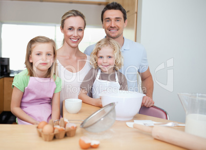 Happy family preparing cookies