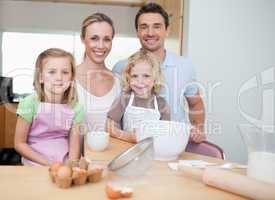 Happy family preparing cookies