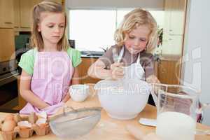 Young siblings preparing dough