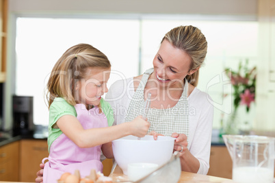 Mother and daughter having fun in the kitchen