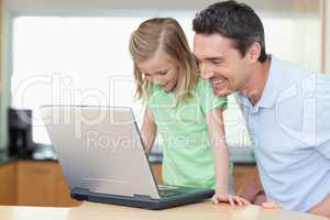 Father and daughter with laptop