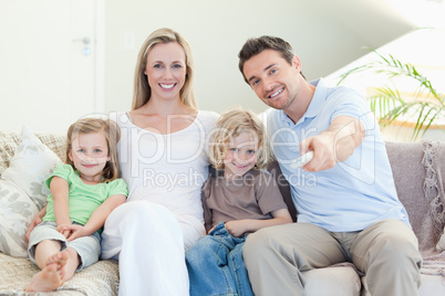 Family watching television on the sofa