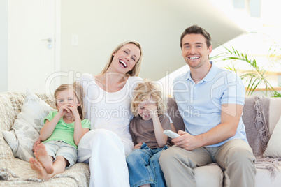 Family laughing on the sofa