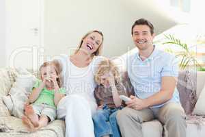 Family laughing on the sofa