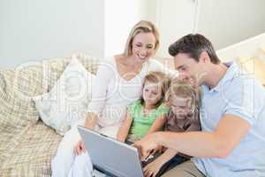 Family on the couch with laptop