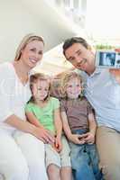 Man taking family picture on couch