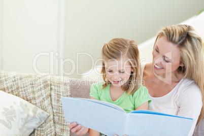 Mother and daughter reading a magazine