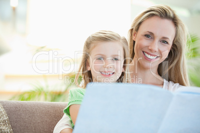 Mother and daughter reading on the sofa