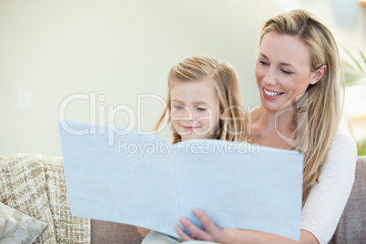 Mother and daughter reading on the couch