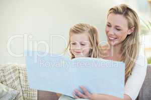 Mother and daughter reading on the couch