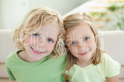 Smiling siblings on the sofa