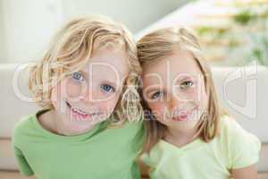 Smiling siblings on the sofa