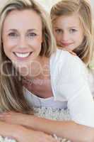 Happy mother and daughter on the floor