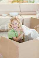 Boy playing with cardboard box