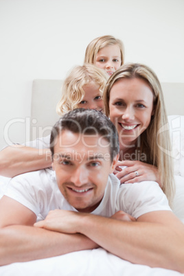 Family enjoying time on the bed