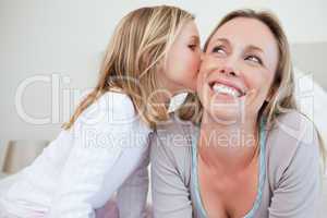 Girl giving her mother a kiss