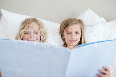 Brother and sister reading bedtime story