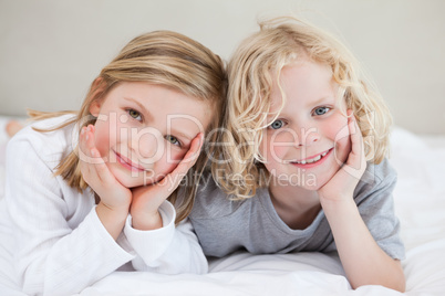 Brother and sister lying on the bed