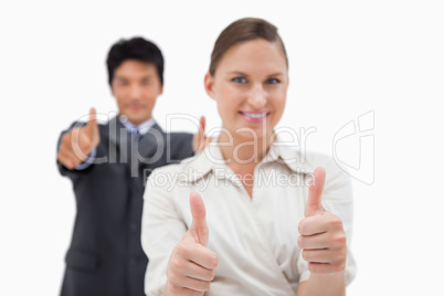 Smiling business people with the thumbs up