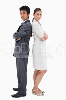 Portrait of business people standing back to back