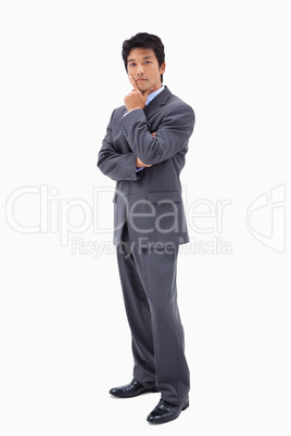 Portrait of a doubtful businessman with the arms crossed