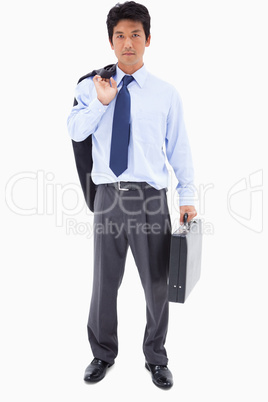 Portrait of a businessman holding a briefcase and his jacket ove