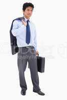 Portrait of a businessman holding a briefcase and his jacket on