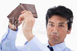 Businessman showing his empty wallet