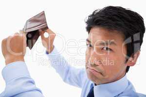 Broke businessman showing his empty wallet