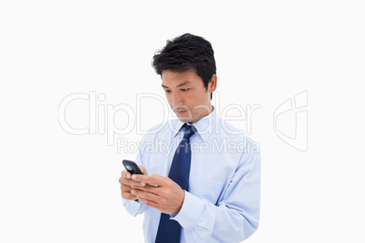 Businessman sending a text message