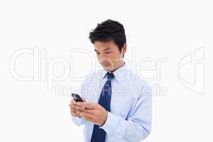 Businessman sending a text message