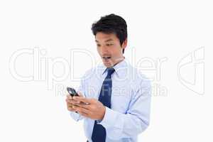 Surprised business man reading a text message