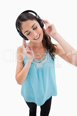 Portrait of a delighted woman listening to music