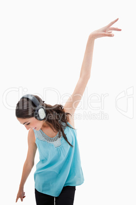 Portrait of a delighted woman dancing while listening to music
