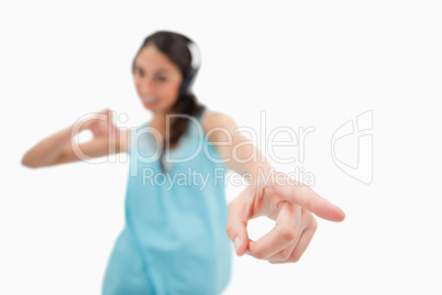Cheerful woman dancing while listening to music