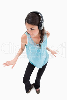 Portrait of a happy woman dancing while listening to music