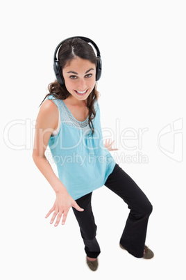 Portrait of a joyful woman dancing while listening to music