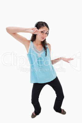 Portrait of a playful woman dancing while listening to music
