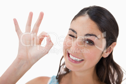 Playful woman signing that everything is fine