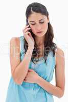 Portrait of a sad woman making a phone call