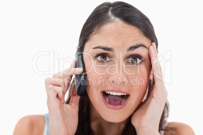 Shocked woman making a phone call