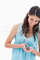 Portrait of a woman sending a text message
