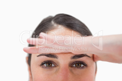 Close up of a woman with her hand on her forehead